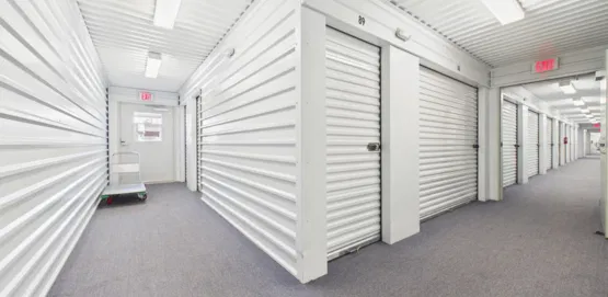 White climate-controlled storage hallway with carpet