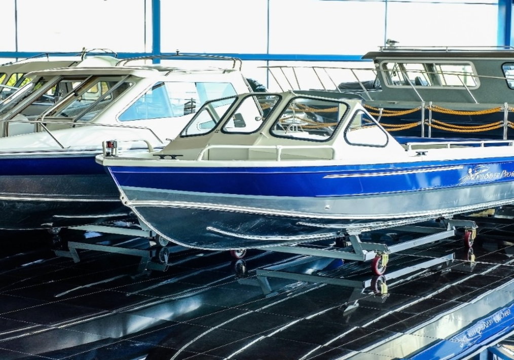 An RV and a boat parked in outdoor storage spaces