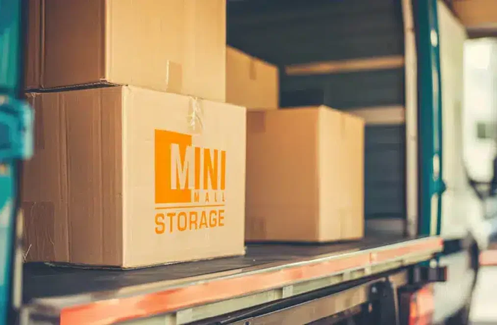 A U-Haul moving truck parked outside a storage facility