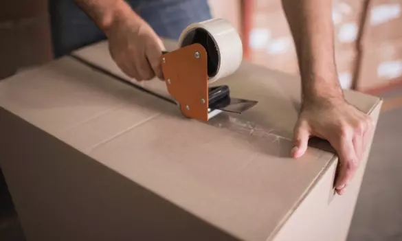 moving-supplies.webp Taping moving box