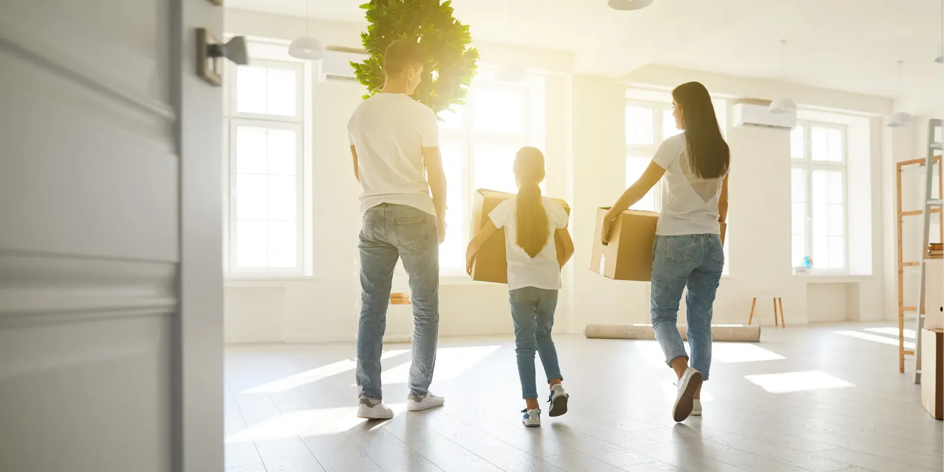 Family carrying moving boxes