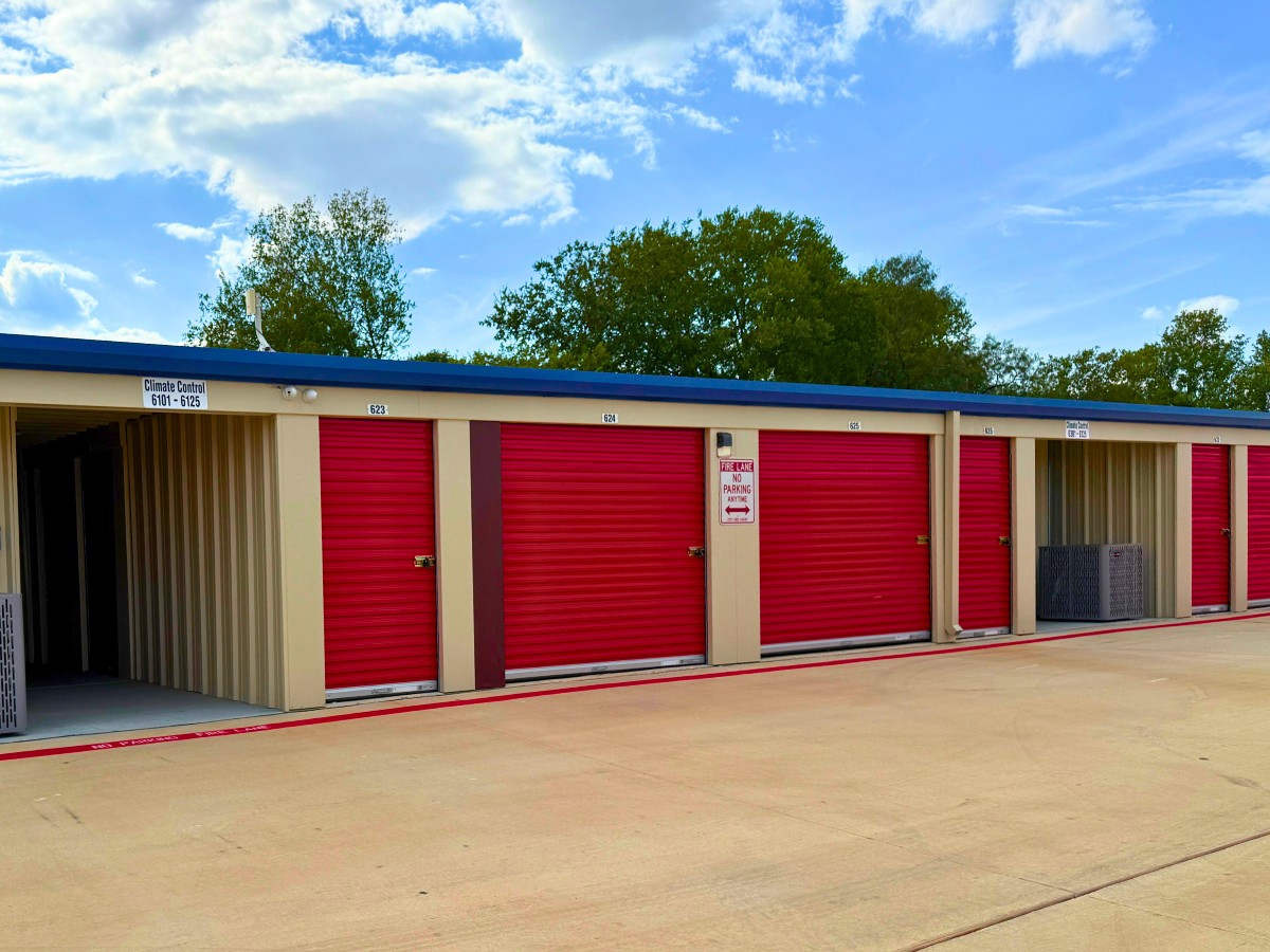 Drive-up storage units beside a climate-controlled building entrance at AAA Storage Georgetown, Texas