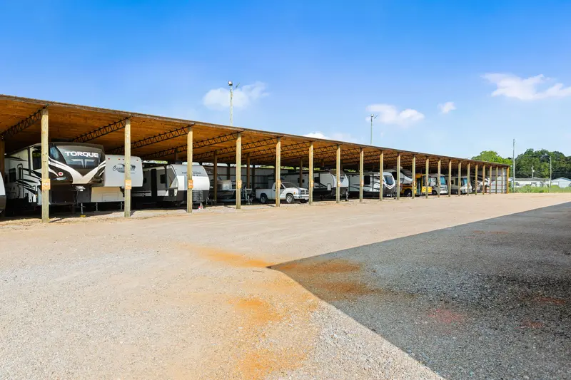 a row of RVs in covered parking bays