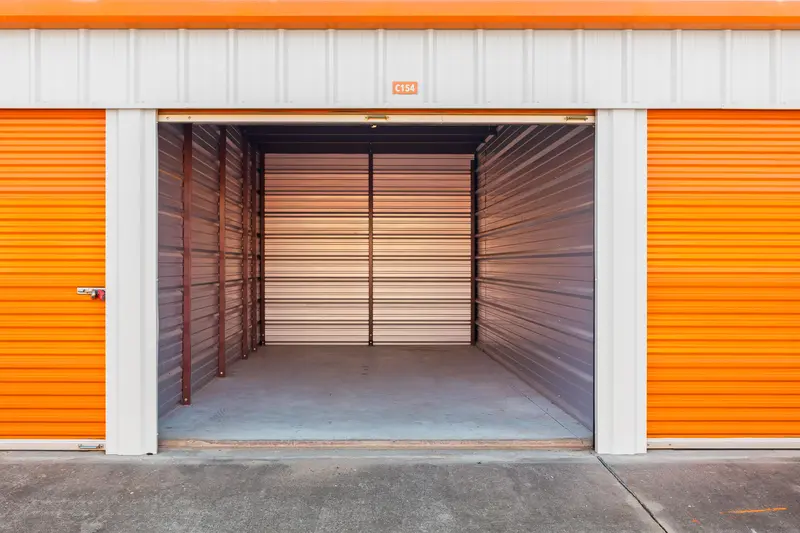 a storage unit with the roll up door pulled back to show the unit interior